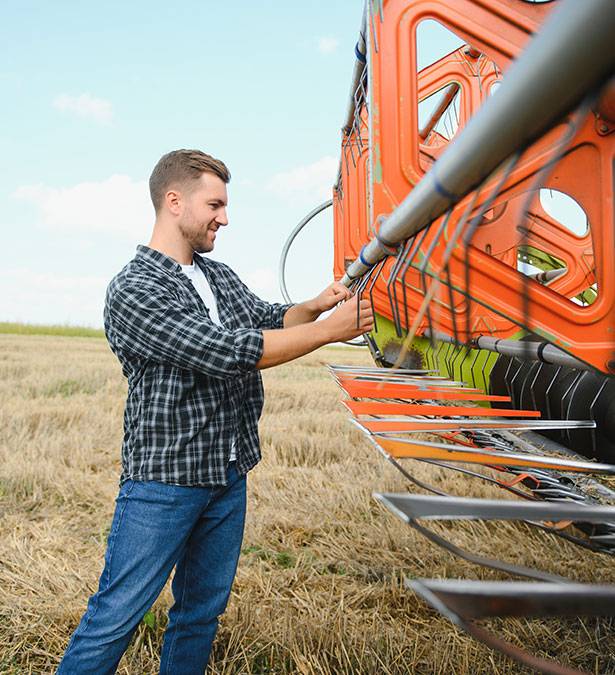 A farming working on sprayer equipment